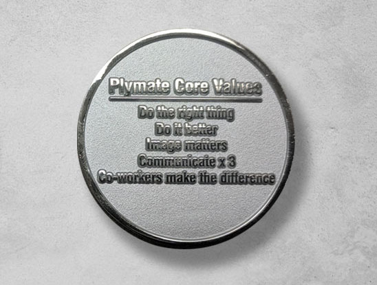 Coin with core values inscribed including: do it better.