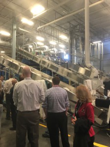 Employees looking at equipment in the Plymate facility