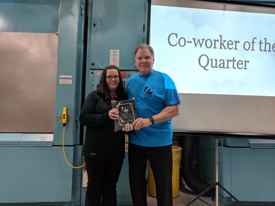 Jessica Palmer receives her award at the quarterly meeting